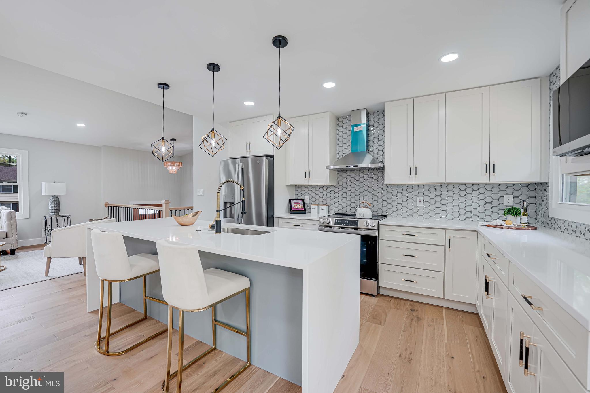 8643 Gateshead Road Alexandria, VA 22309 - Photo 12 of 40 a kitchen with stainless steel appliances kitchen island granite countertop a sink and cabinets