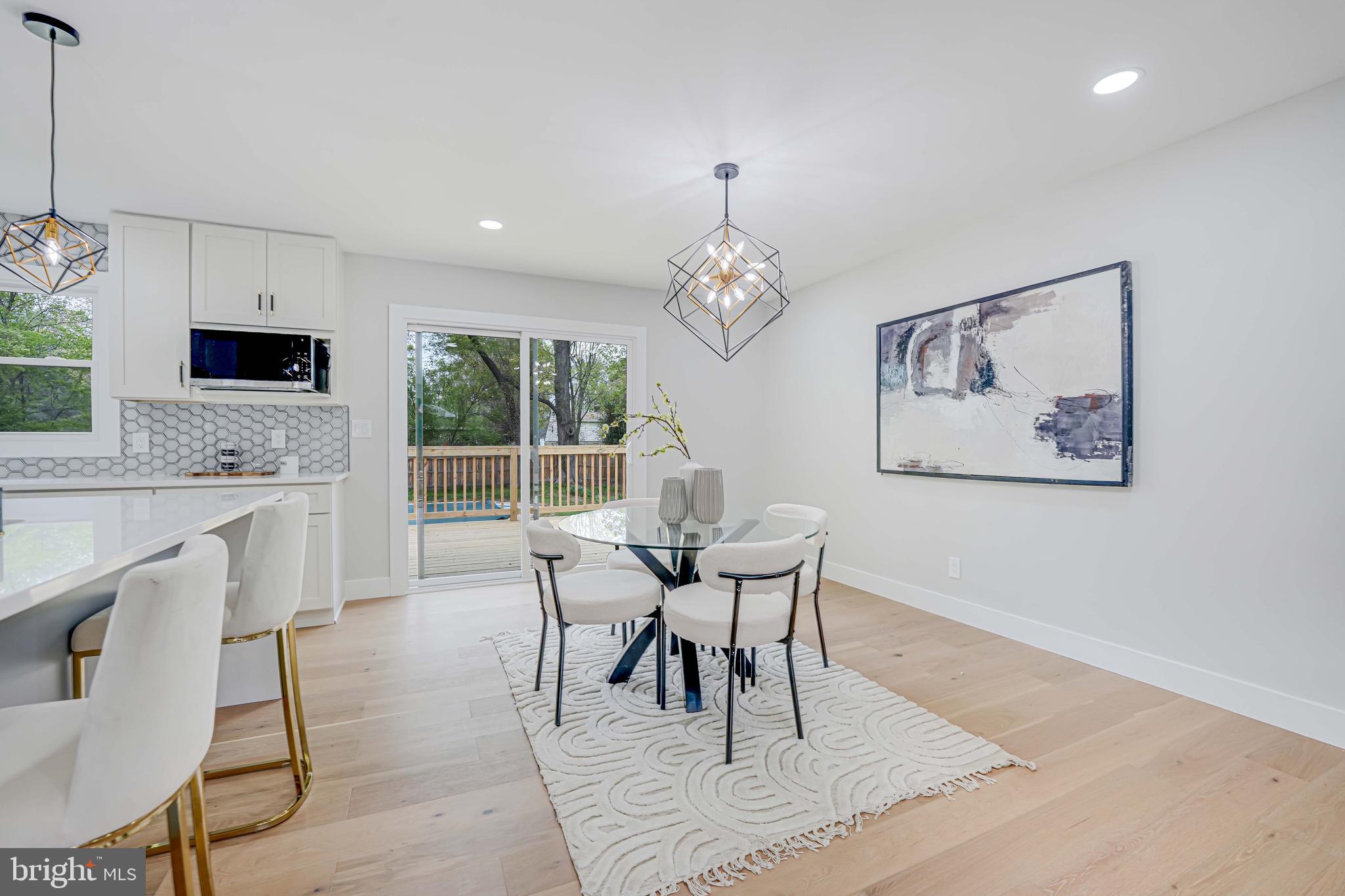 8643 Gateshead Road Alexandria, VA 22309 - Photo 14 of 40 a dining room with wooden floor and a chandelier