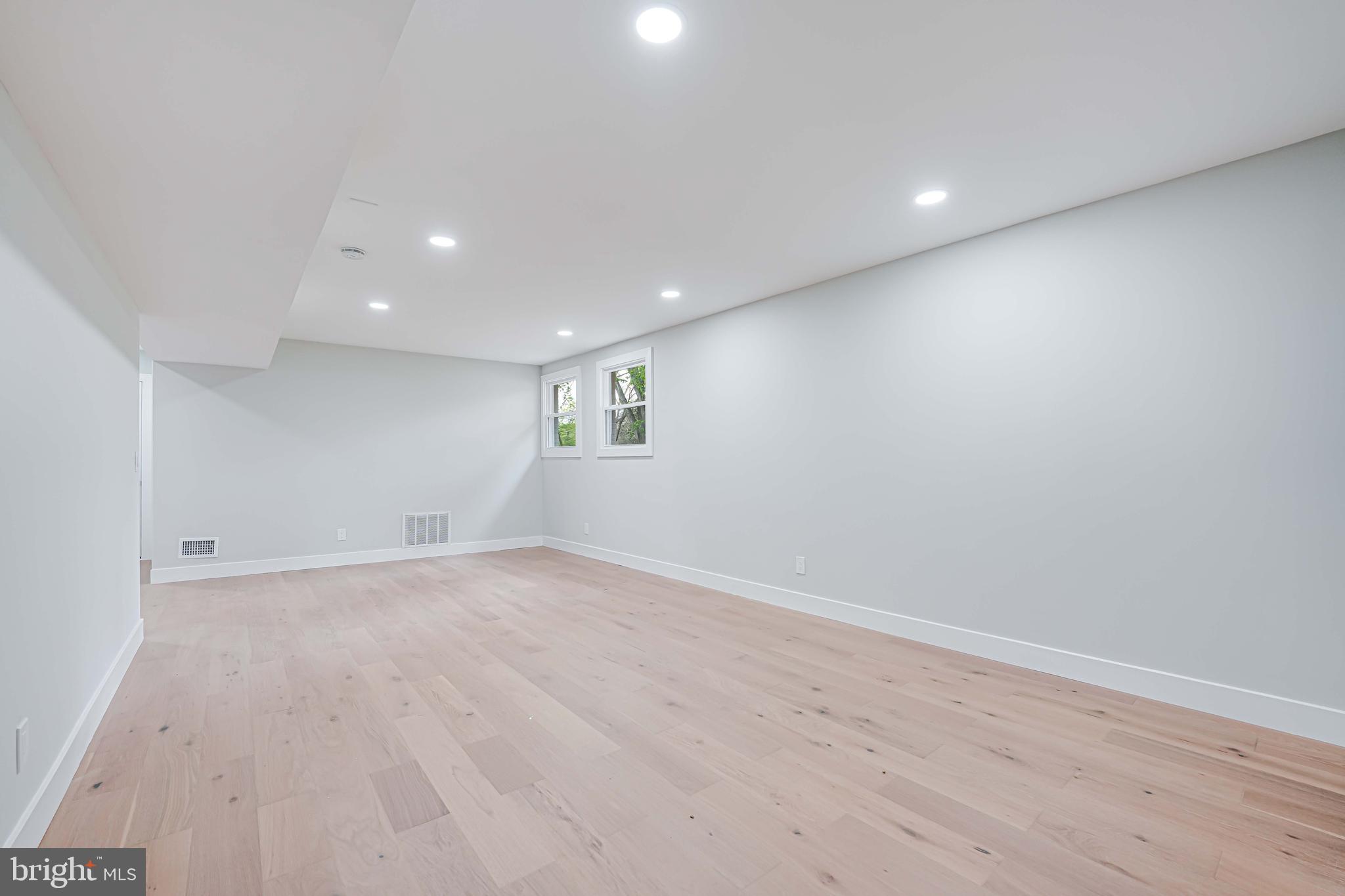 8643 Gateshead Road Alexandria, VA 22309 - Photo 29 of 40 an empty room with wooden floor and windows