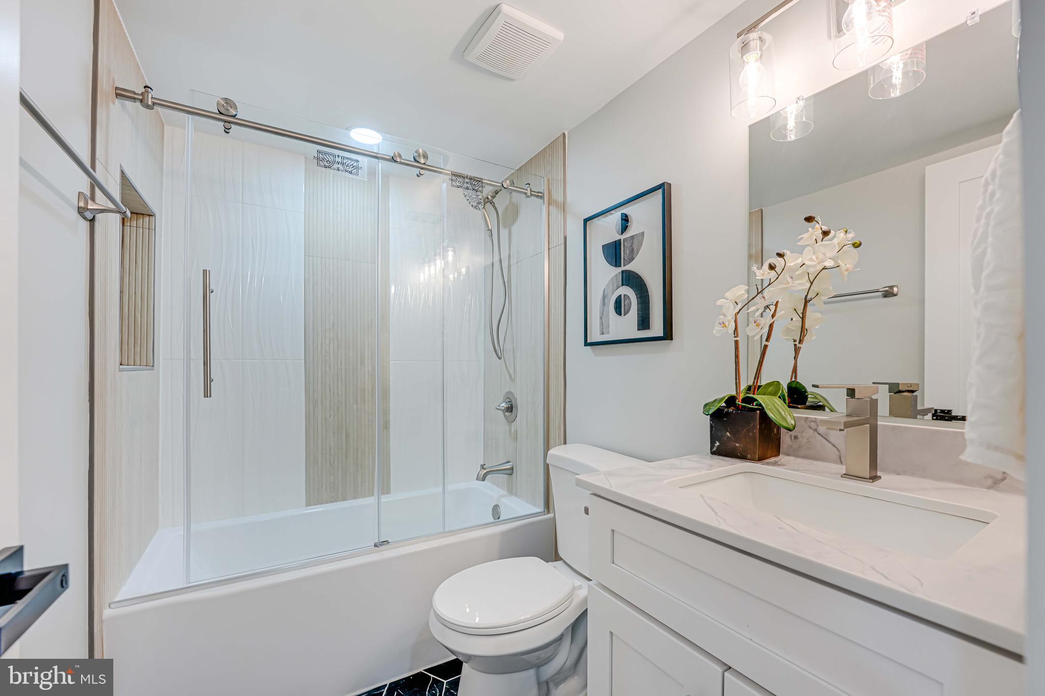 8643 Gateshead Road Alexandria, VA 22309 - Photo 32 of 40 a bathroom with a sink a toilet and shower