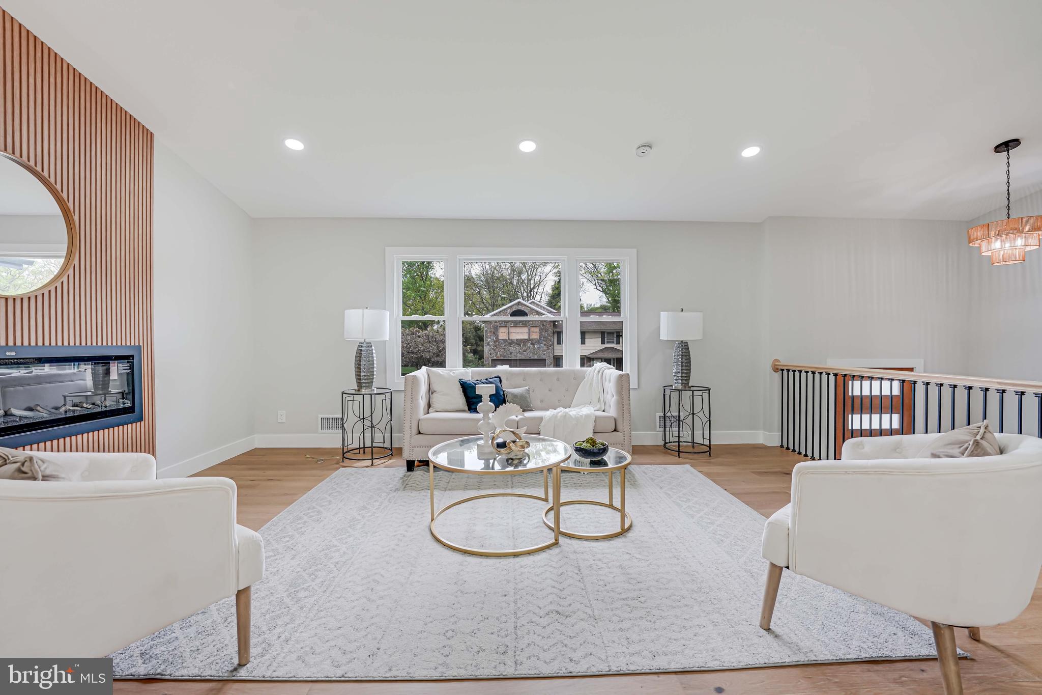 8643 Gateshead Road Alexandria, VA 22309 - Photo 6 of 40 a living room with furniture a fireplace and a floor to ceiling window