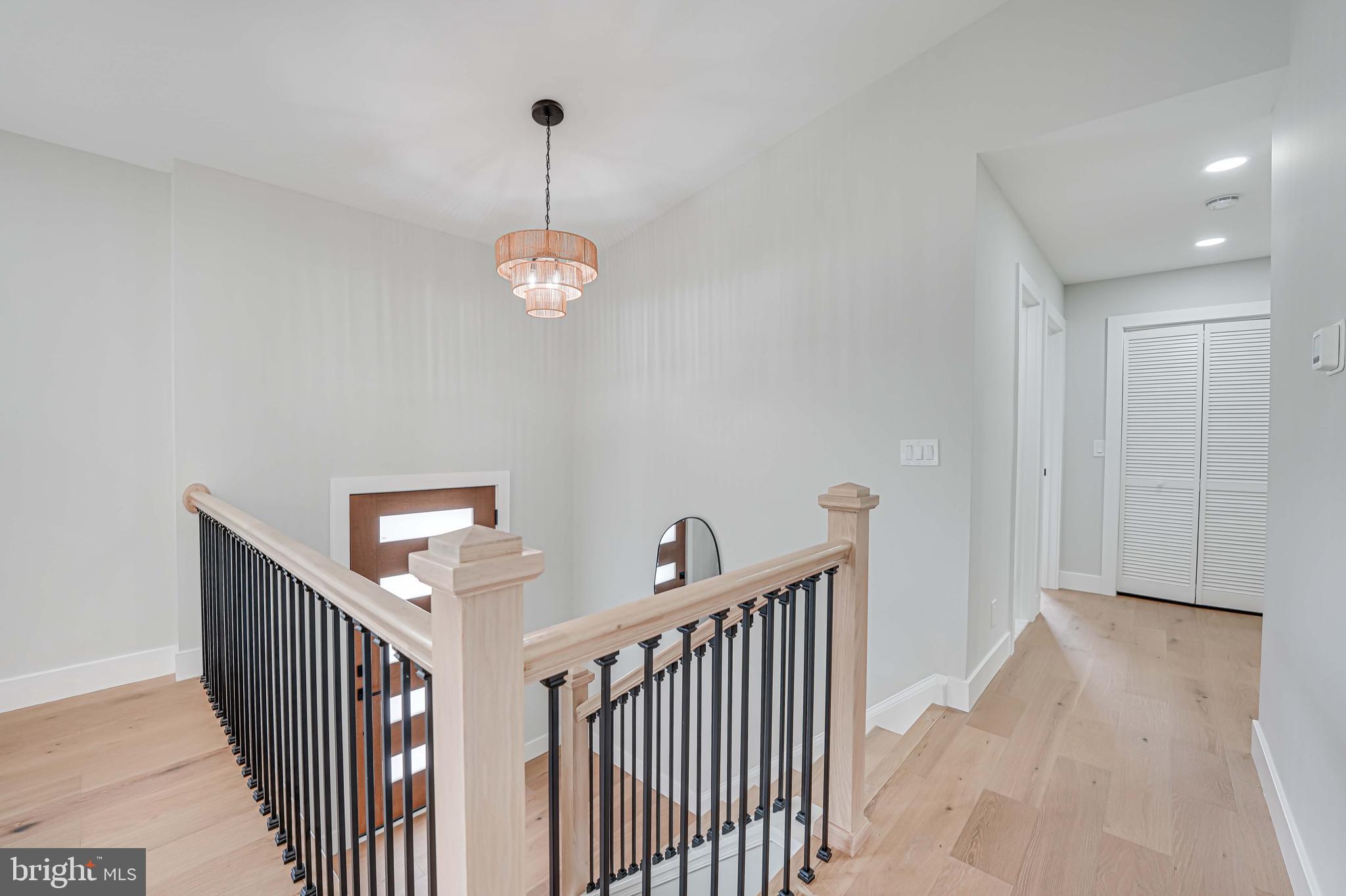 8643 Gateshead Road Alexandria, VA 22309 - Photo 7 of 40 a view of a hallway with a chandelier
