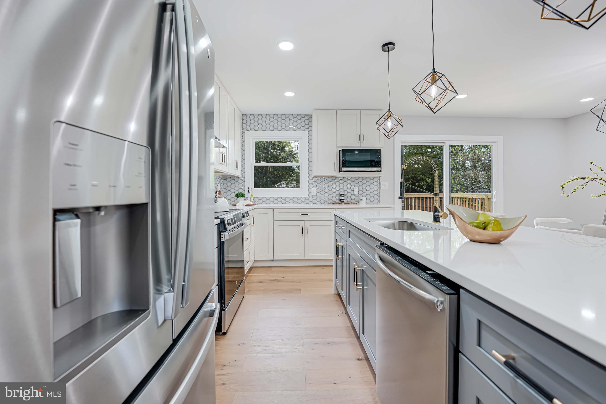 8643 Gateshead Road Alexandria, VA 22309 - Photo 9 of 40 a kitchen with a sink stainless steel appliances and white cabinets