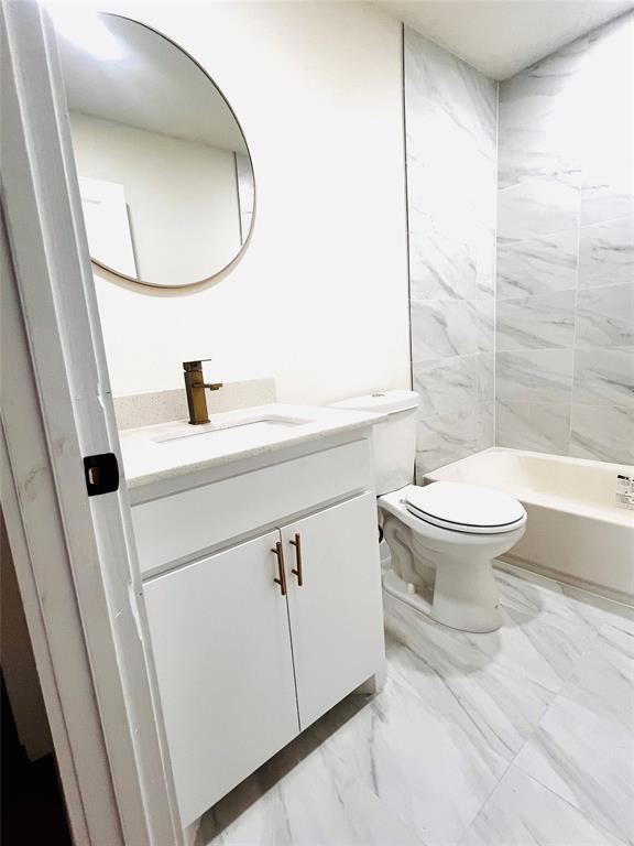 3719 Meadow Street Dallas, TX 75215 - Photo 11 of 18 a bathroom with a sink a toilet and a mirror