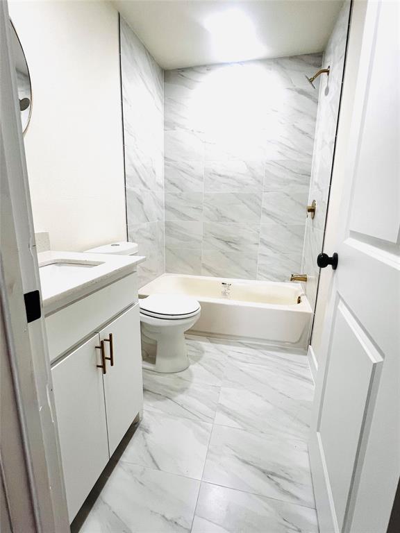 3719 Meadow Street Dallas, TX 75215 - Photo 12 of 18 a bathroom with a sink a toilet and a bathtub