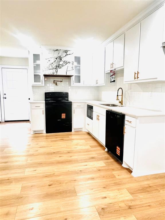 3719 Meadow Street Dallas, TX 75215 - Photo 7 of 18 a kitchen with granite countertop a stove cabinets and wooden floor