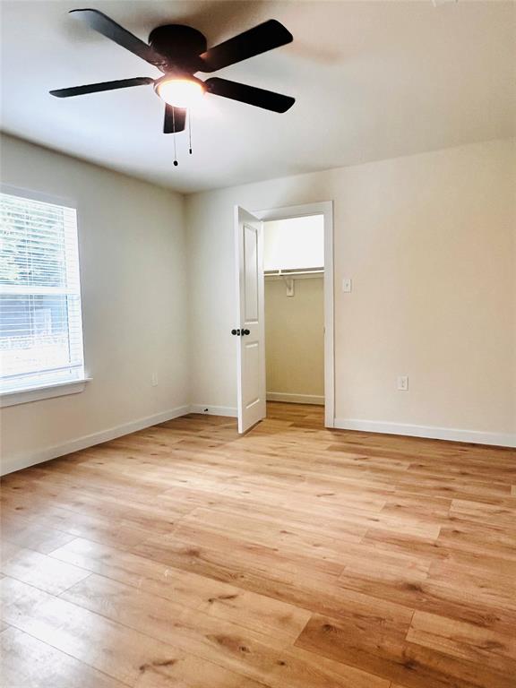 3719 Meadow Street Dallas, TX 75215 - Photo 10 of 18 an empty room with wooden floor and windows