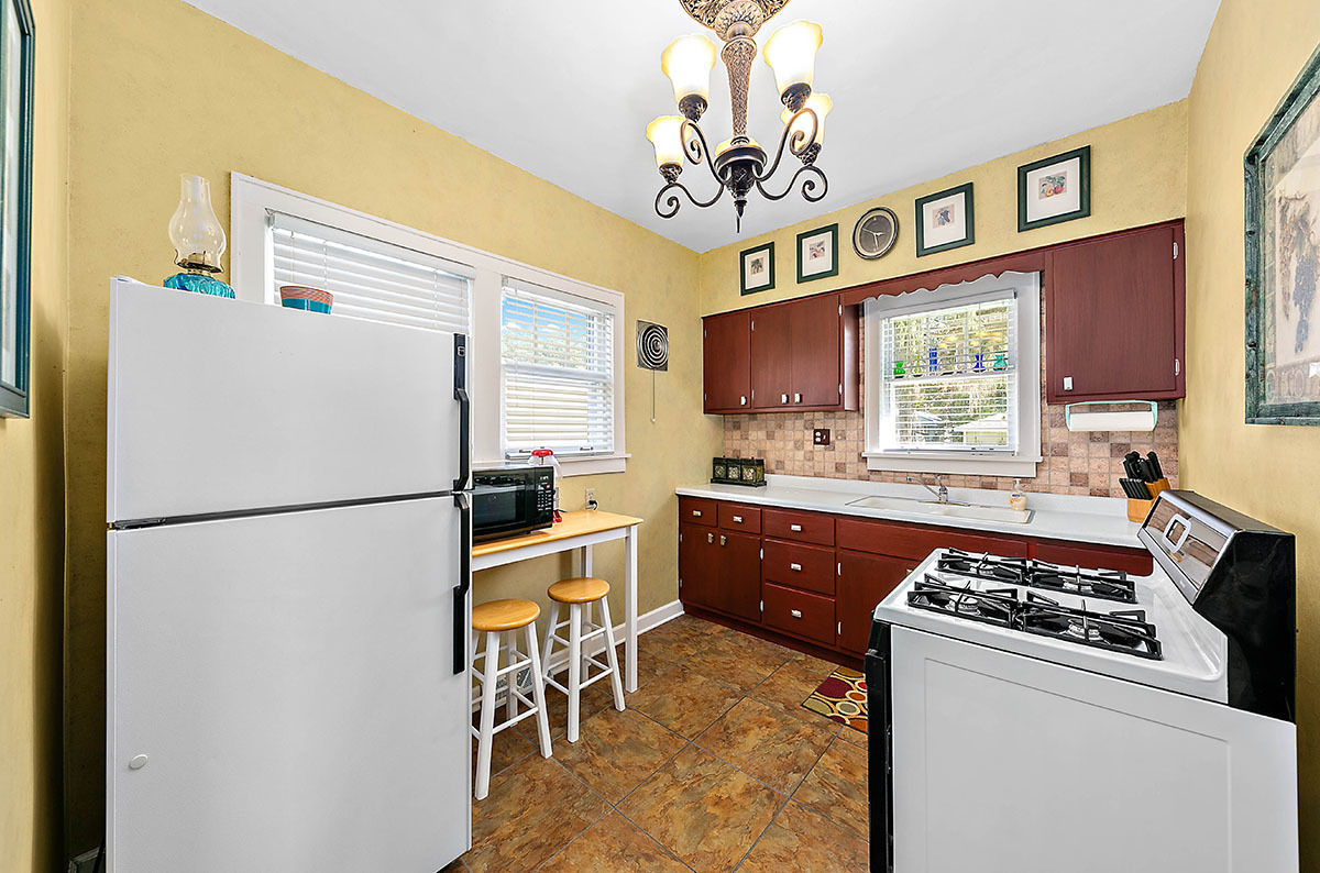 826 North Center Street Naperville, IL 60563 - Photo 8 of 21 a kitchen with stainless steel appliances granite countertop a refrigerator a stove a sink dishwasher and white cabinets with wooden floor