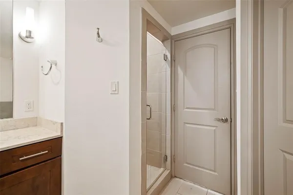 a bathroom with a shower and a sink