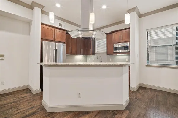 a view of a kitchen with a sink and wooden floor