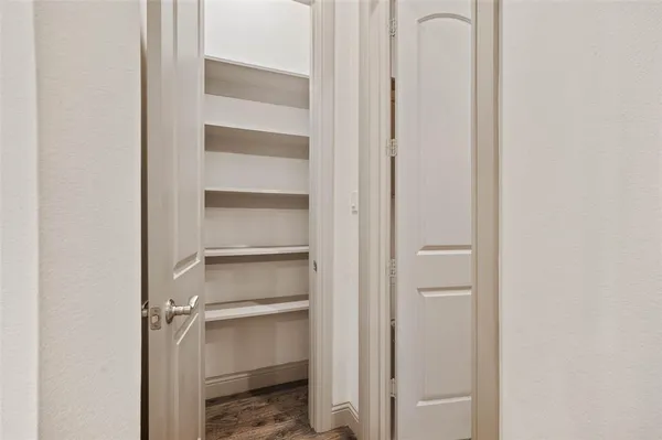 a view of an empty walk in closet with empty racks