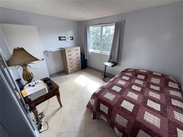 a bedroom with two beds and a window