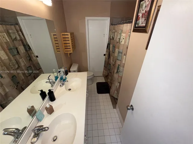 a bathroom with a sink mirror and shower
