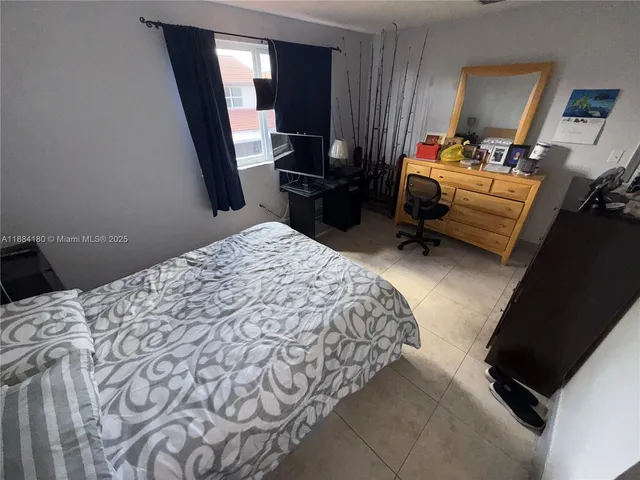 a bedroom with a bed and a mirror in it