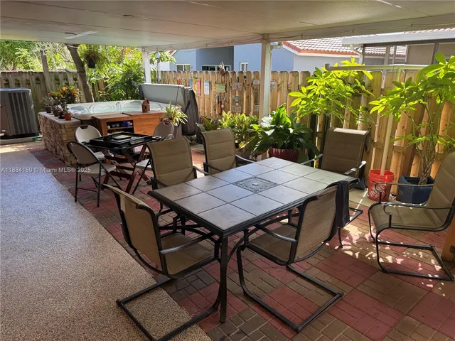 a view of a tables and chairs in patio