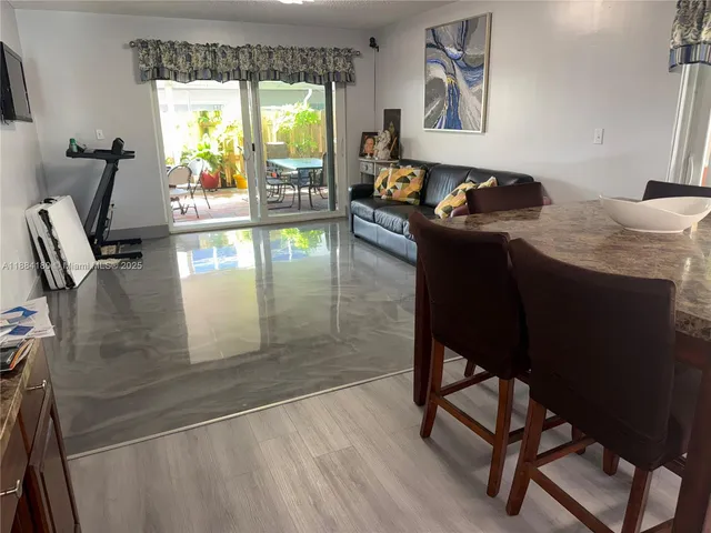 a living room with furniture and a floor to ceiling window
