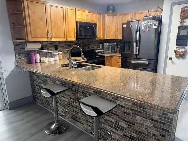 a kitchen with a table chairs and a window
