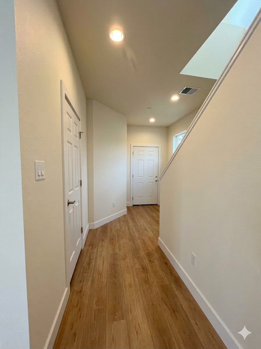 a view of hallway with wooden floor
