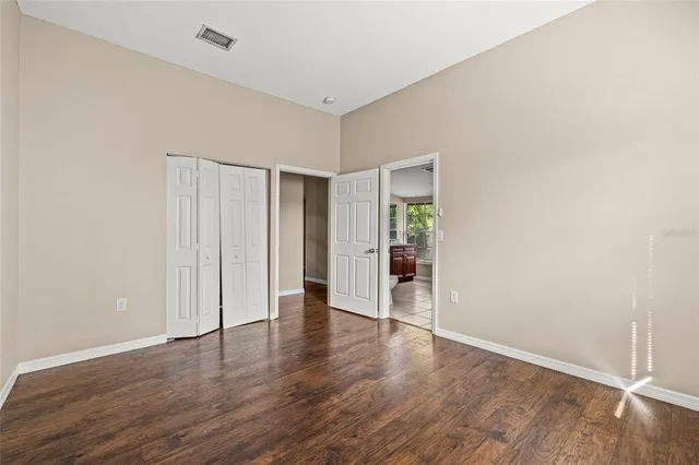 a view of an empty room with wooden floor