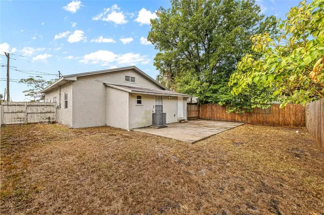 a backyard of a house with large trees