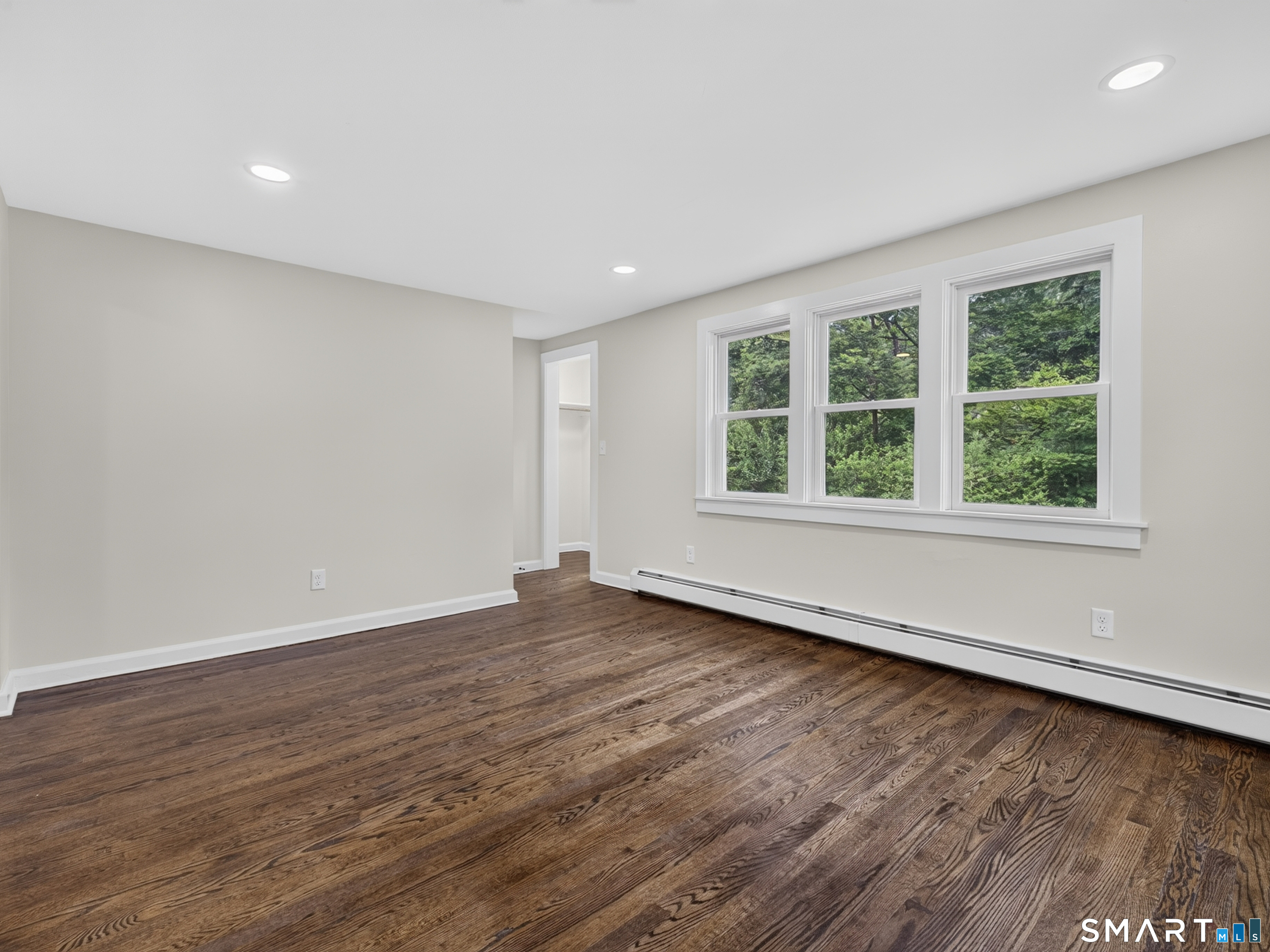 1039 N Road Groton, CT 06340 - Photo 6 of 26 an empty room with wooden floor and windows