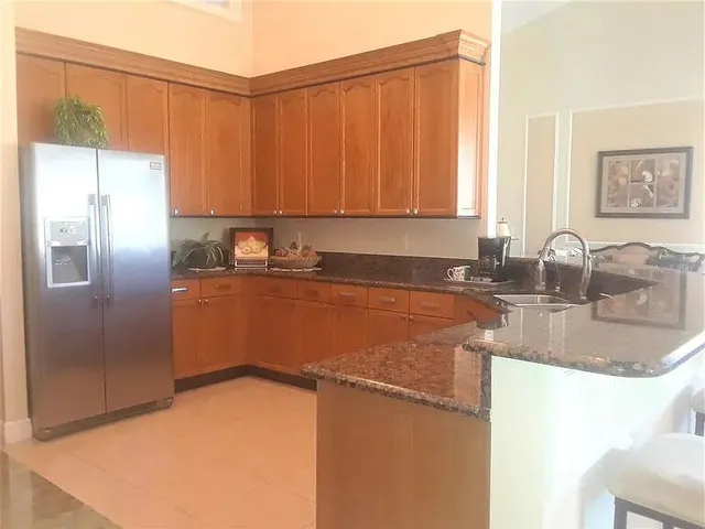 a kitchen with a sink cabinets and window