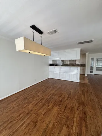 a view of a kitchen with wooden floor and a sink
