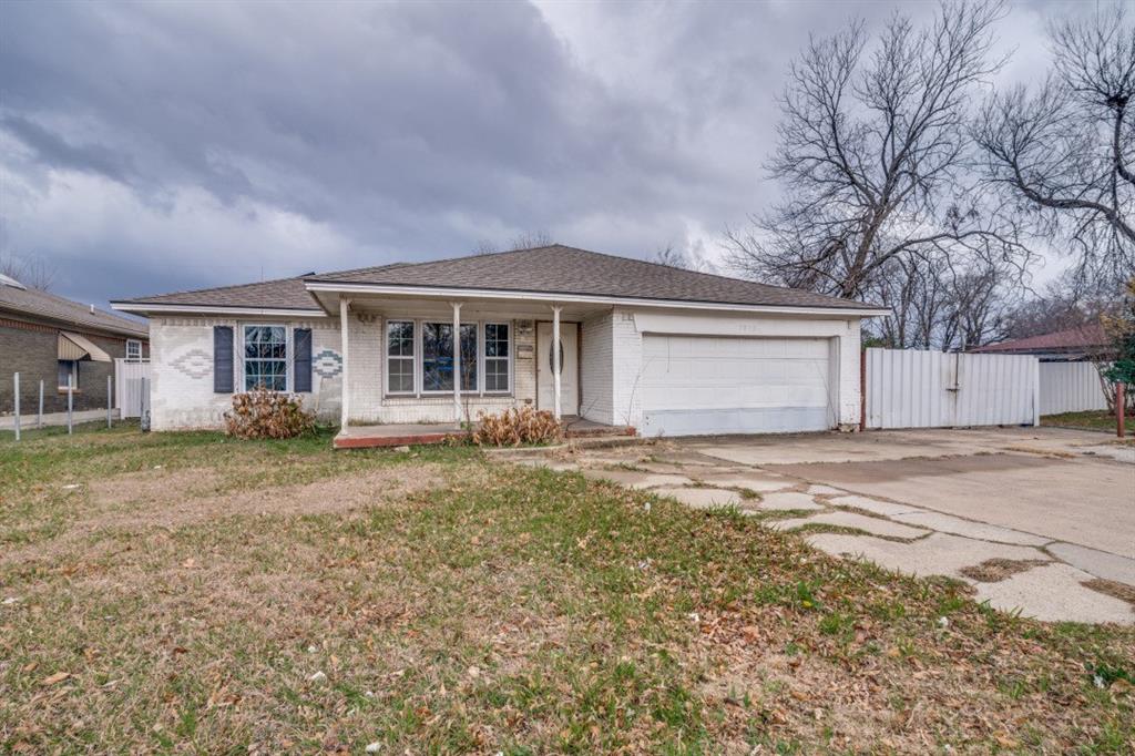 a front view of a house with a garden and yard