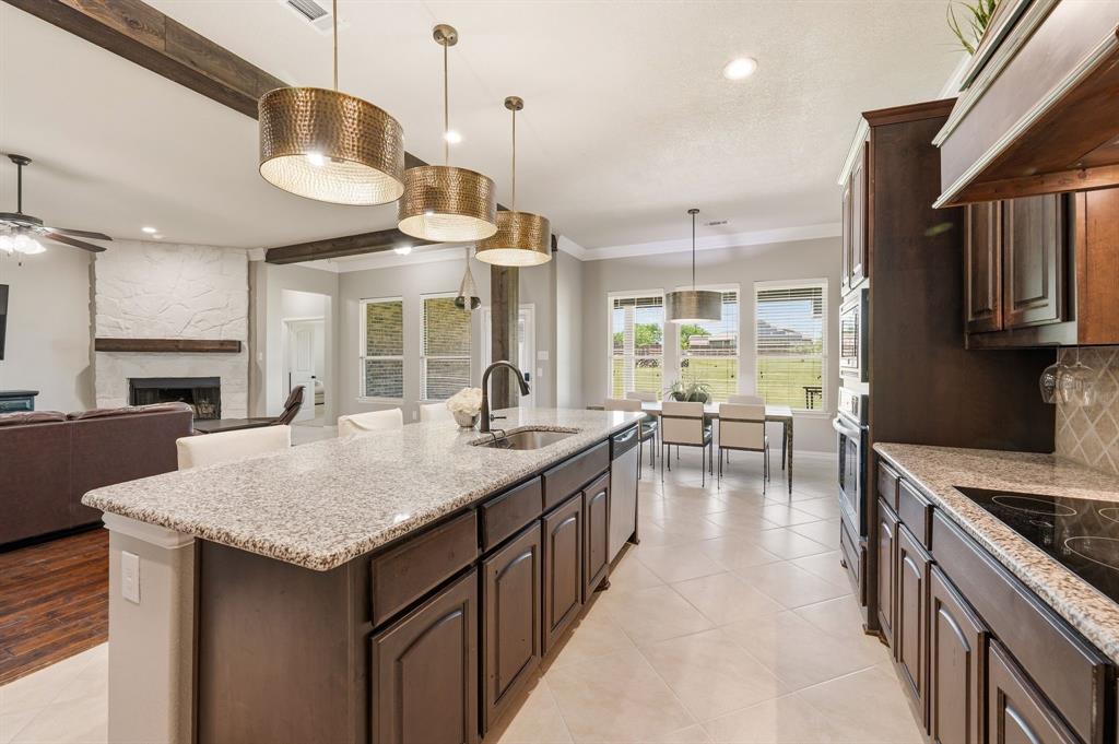 140 Heather Lane Decatur, TX 76234 - Photo 15 of 39 a kitchen with center island table and chairs