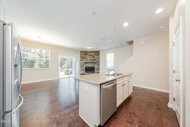 a kitchen with stainless steel appliances granite countertop a stove and a refrigerator
