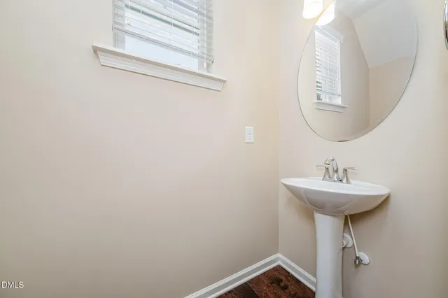a bathroom with a sink a mirror and a window