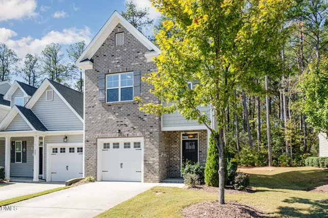 a picture of a bench in front of a white house