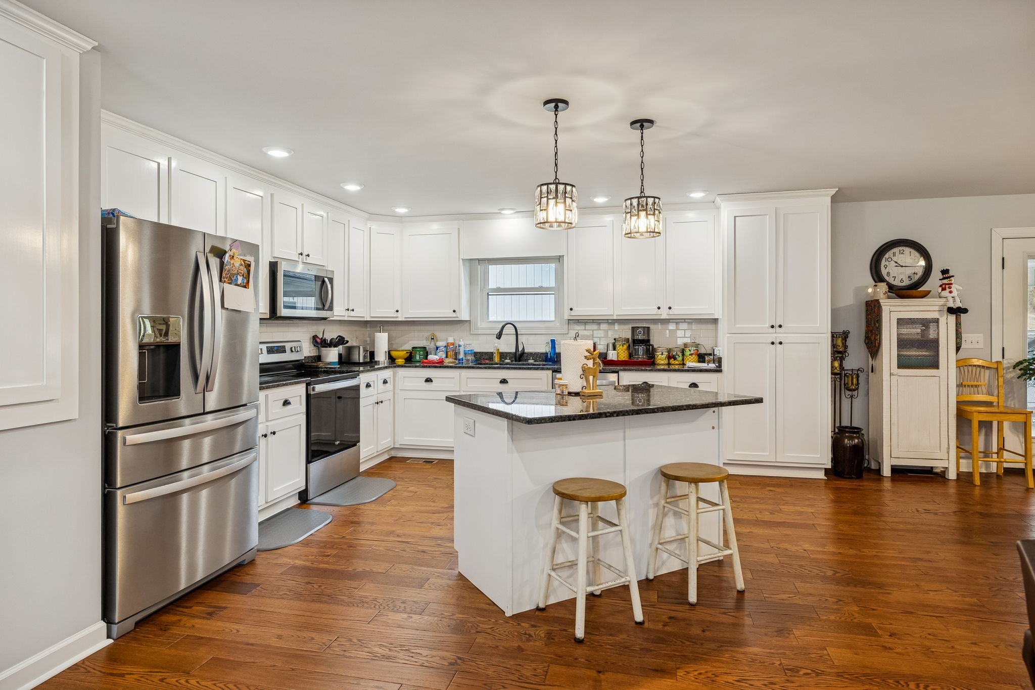 76 Cathcart Road Frankewing, TN 38459 - Photo 18 of 25 a kitchen with stainless steel appliances granite countertop a refrigerator a stove top oven a sink dishwasher and white cabinets with wooden floor