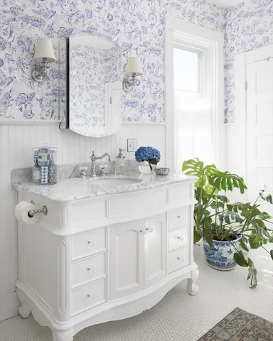 a bathroom with a sink a vanity and a window