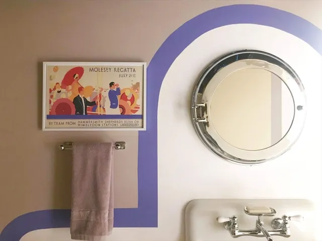 a bathroom with a toilet and a mirror