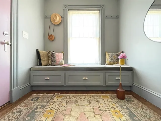 a room with a window and dresser