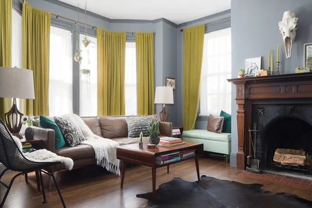 a living room with furniture and a fireplace