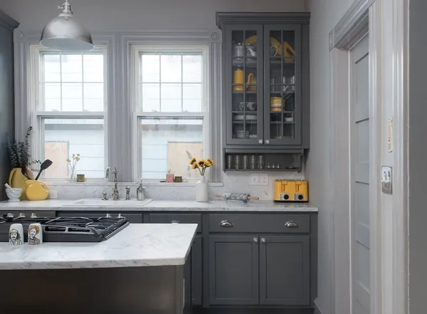 a kitchen with a stove a sink and a window