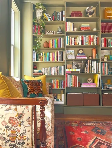 a view of living room with furniture and book shelf