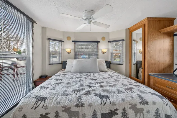 a large bedroom with a large bed and a chandelier