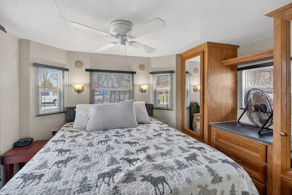 a bedroom with a large bed and a chandelier