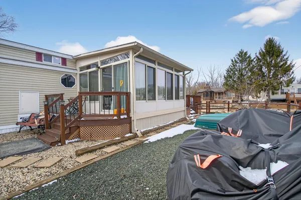 a view of a house with backyard and sitting area