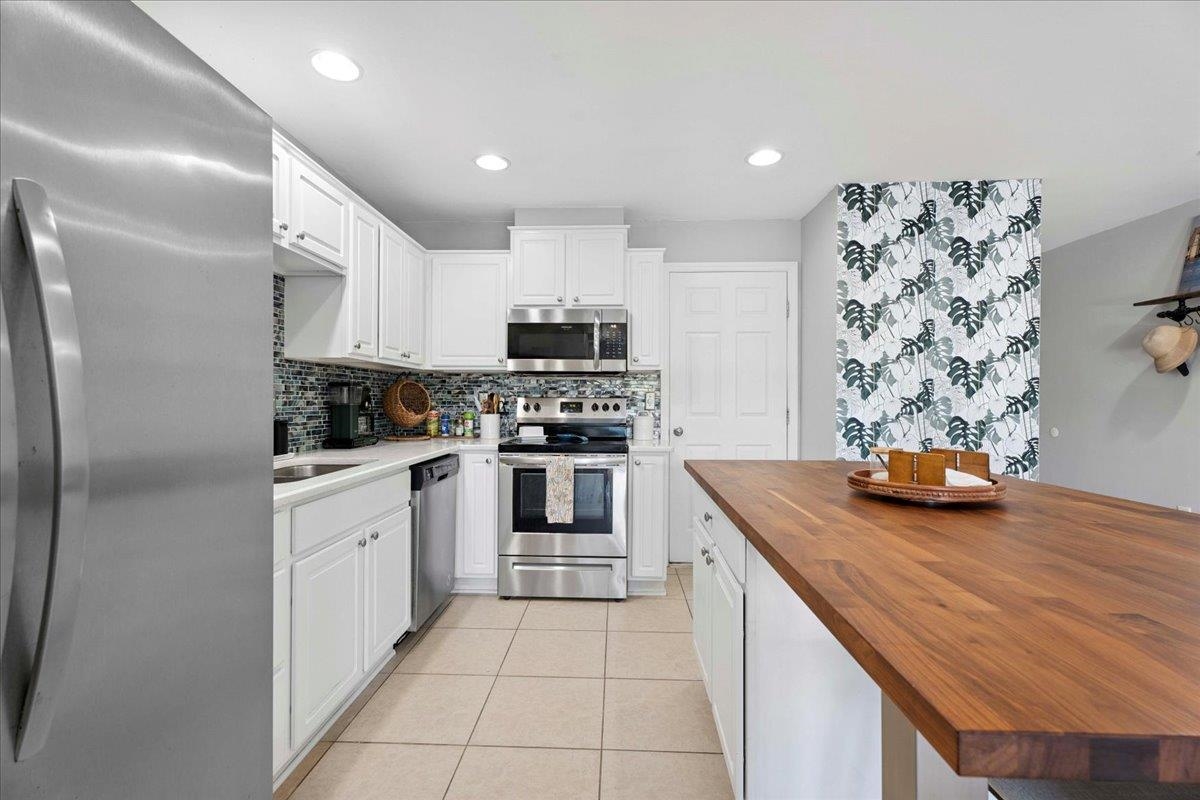 171 Islander Drive St. Augustine, FL 32080 - Photo 11 of 36 a kitchen with stainless steel appliances kitchen island granite countertop a sink and cabinets