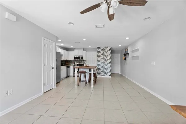 a kitchen with stainless steel appliances kitchen island granite countertop a refrigerator and a sink