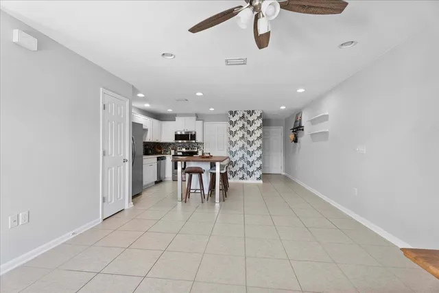 a kitchen with stainless steel appliances kitchen island granite countertop a refrigerator and a sink