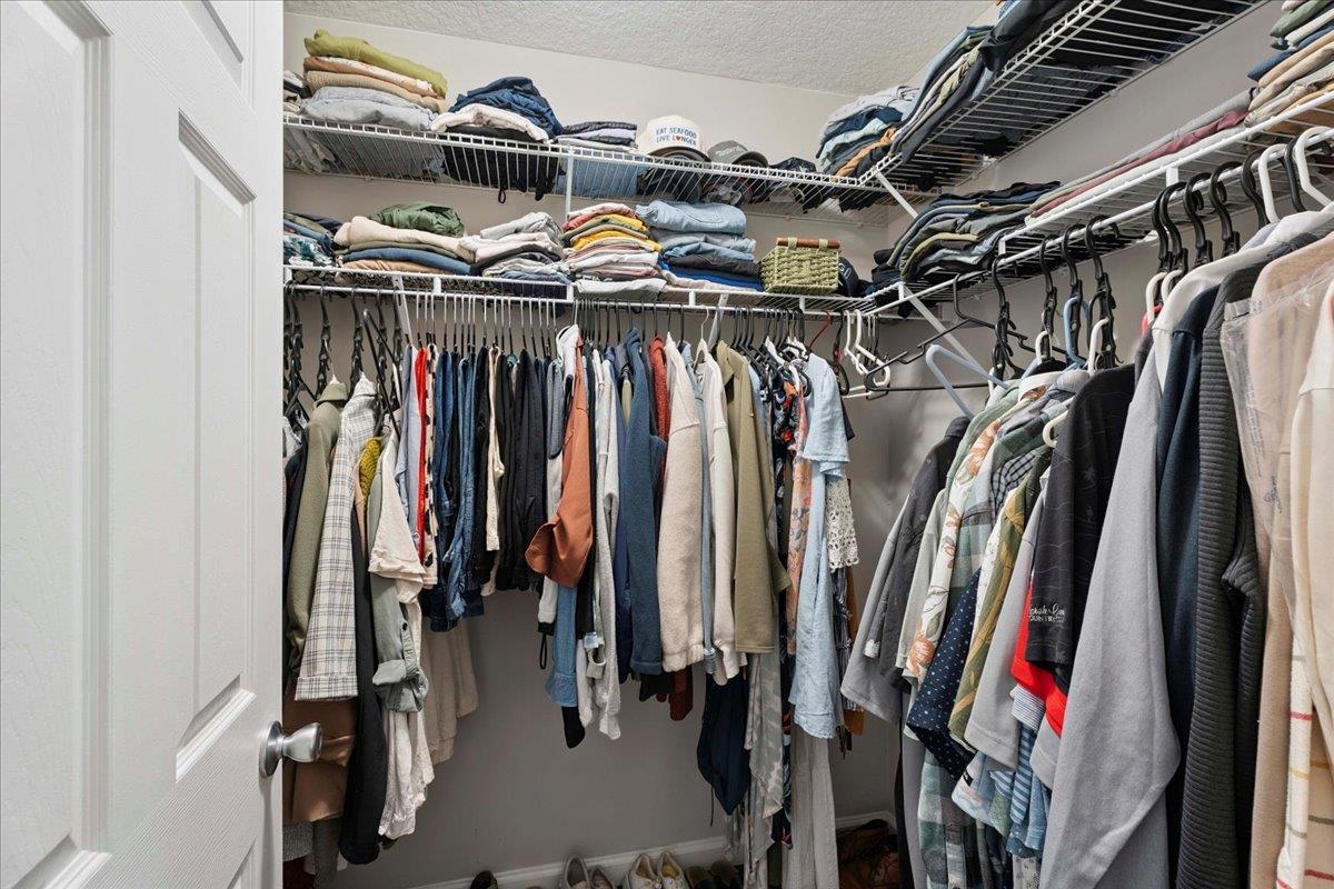 171 Islander Drive St. Augustine, FL 32080 - Photo 17 of 36 a view of walk in closet with clothes and shoes