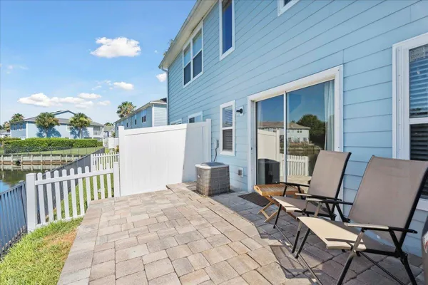 a view of a patio with a table and chairs