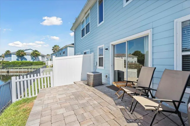 a view of a patio with a table and chairs
