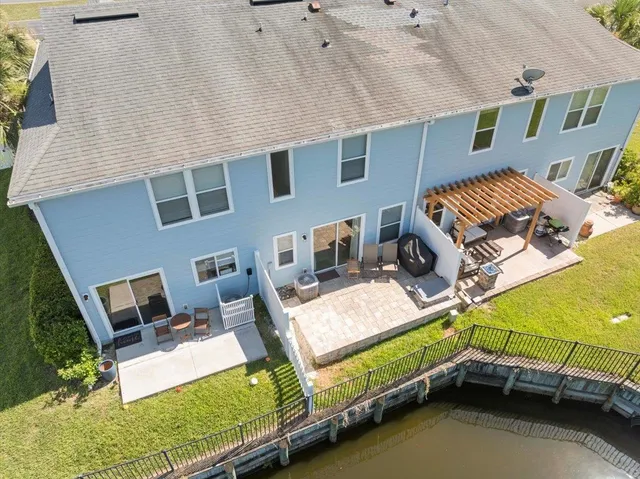 a backyard of a house with table and chairs