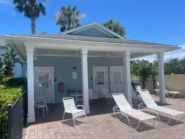 a view of a patio with a table and chairs and potted plants